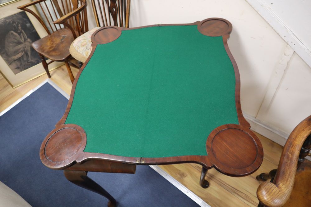 A George I red walnut serpentine top card table, with dished corners, frieze drawer and slender cabriole legs, width 82cm